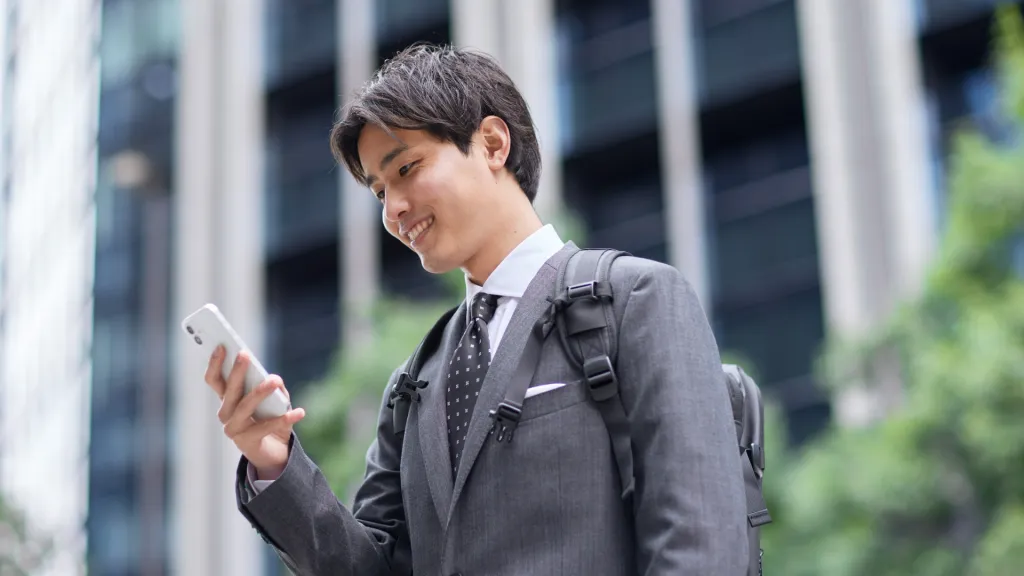 a man in a suit looking at a cellphone